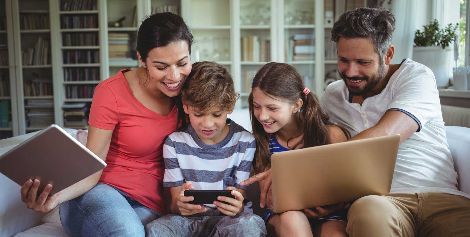 Family in home using internet on multiple devices